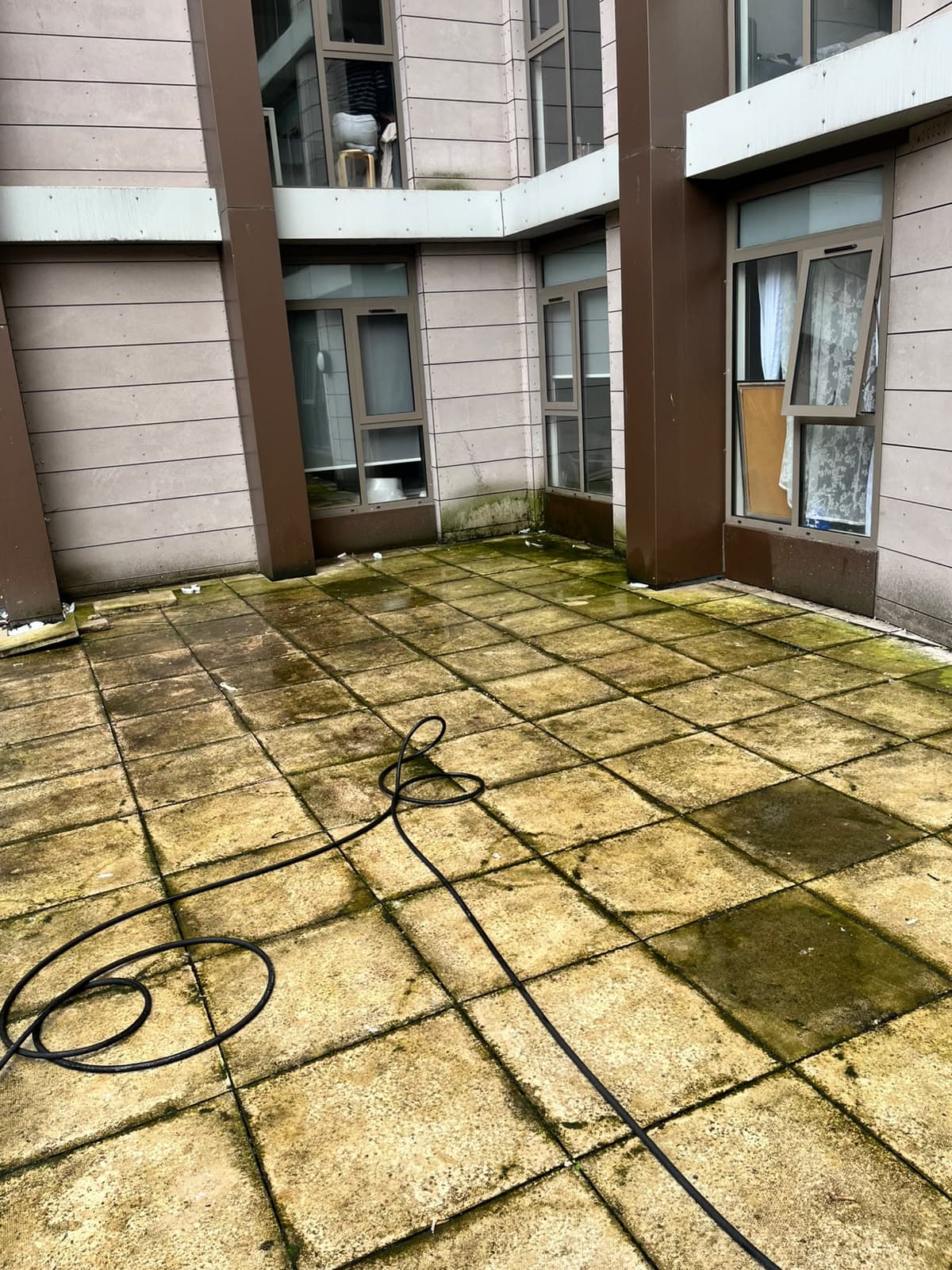 Balcony paving before pressure washing at One Wolstenholme Square