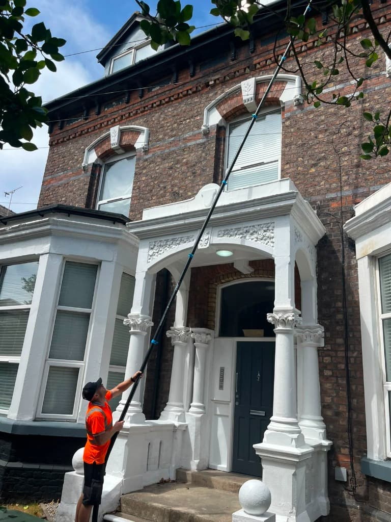 Water fed pole reaching an upper window of a Victorian house