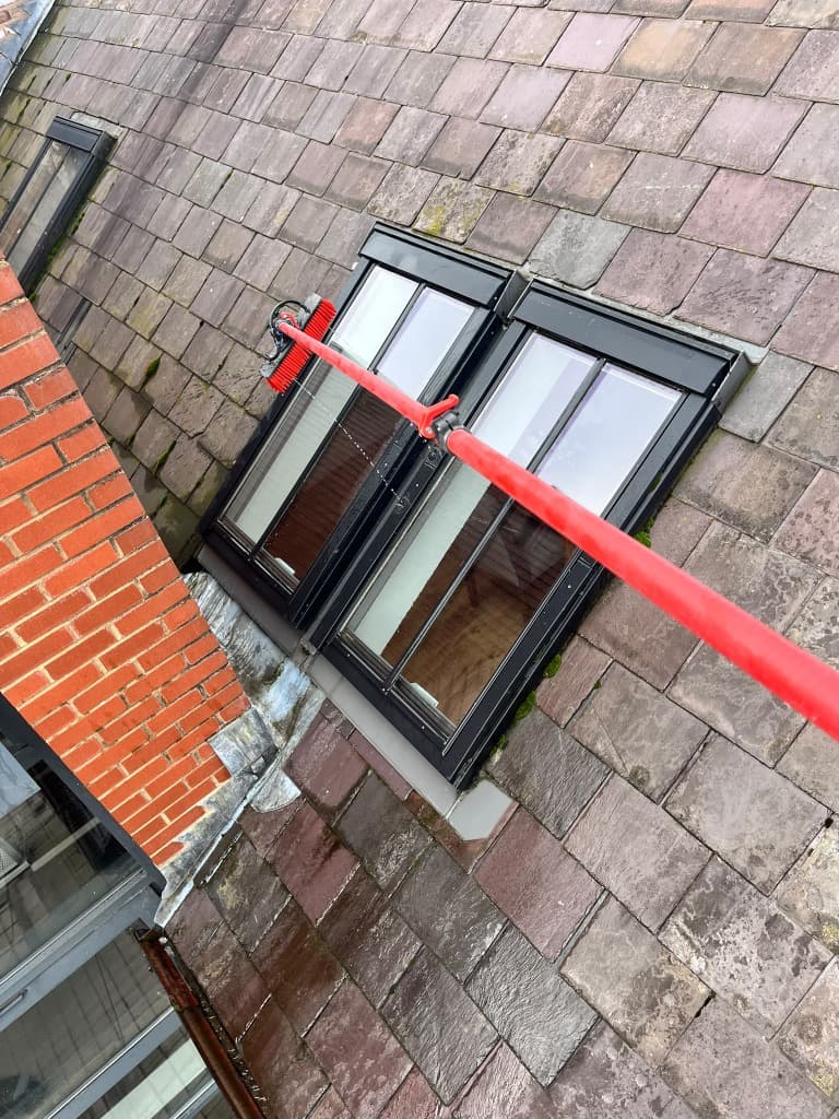 Water fed brush cleaning external roof windows on a Liverpool property